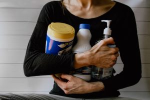 woman holding cleansers